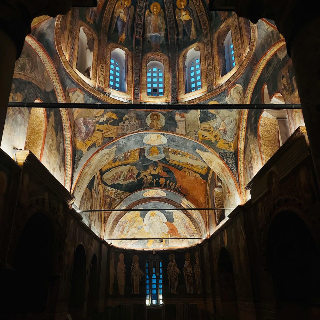 Majestic Byzantine frescoes adorn the ceiling of an ancient church, showcasing vibrant religious art.